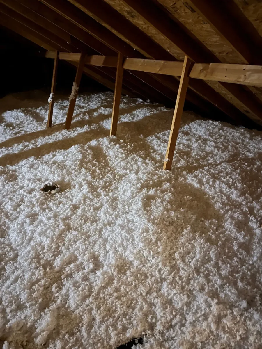 Close view of textured fiberglass insulation across an attic floor