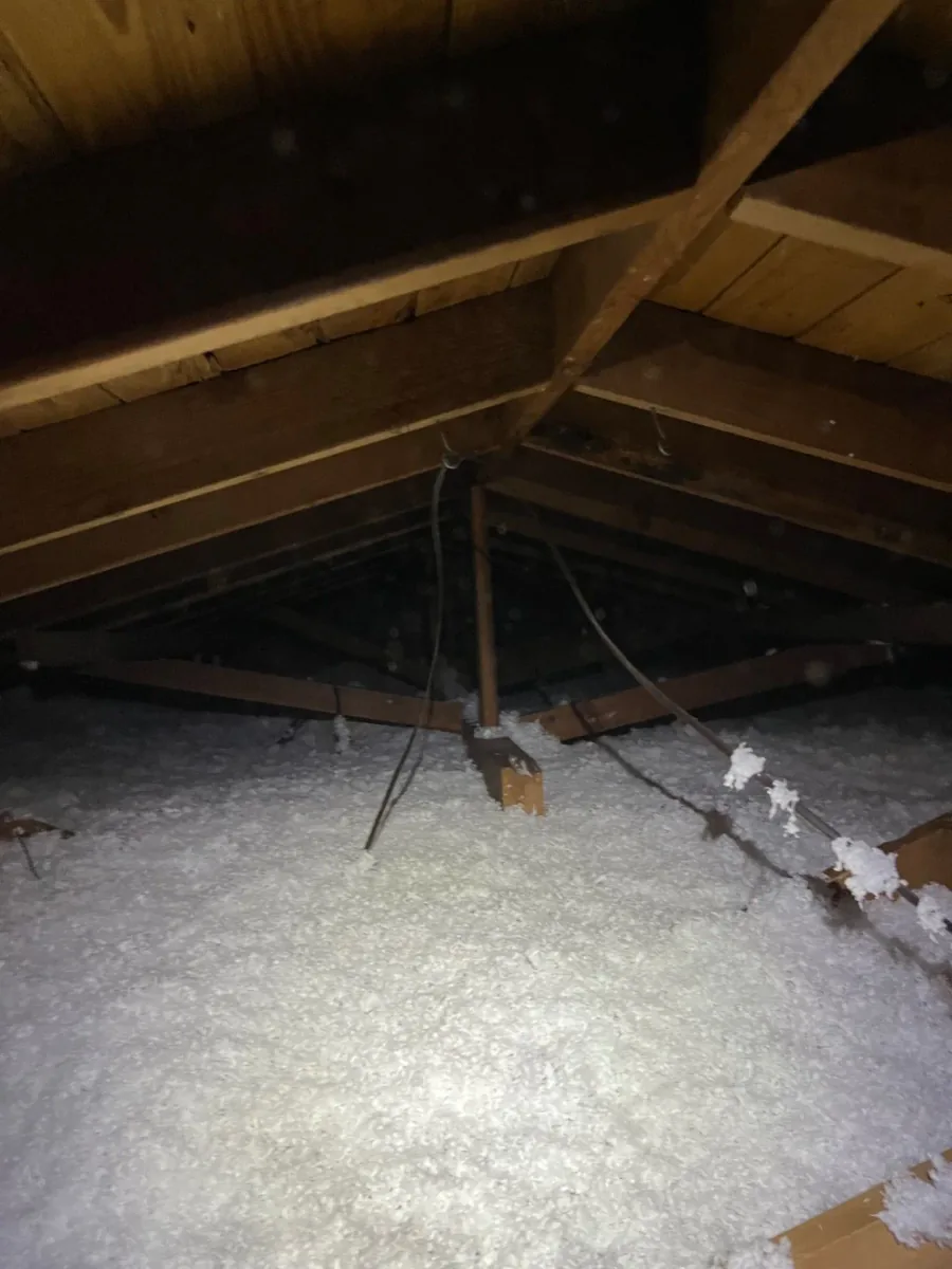 Even fiberglass insulation coverage beneath the rafters of an attic